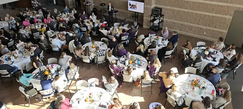 PRC Networking Day Banner. Attendees listen to Mike Spencer.