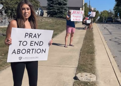 ProLife Life Chain woman holding sign